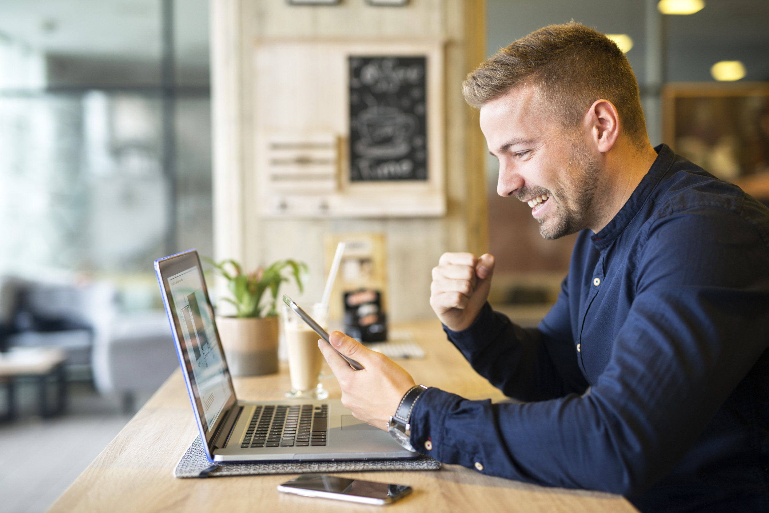 Man with Laptop laughing