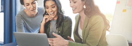 3 Women looking at laptops.