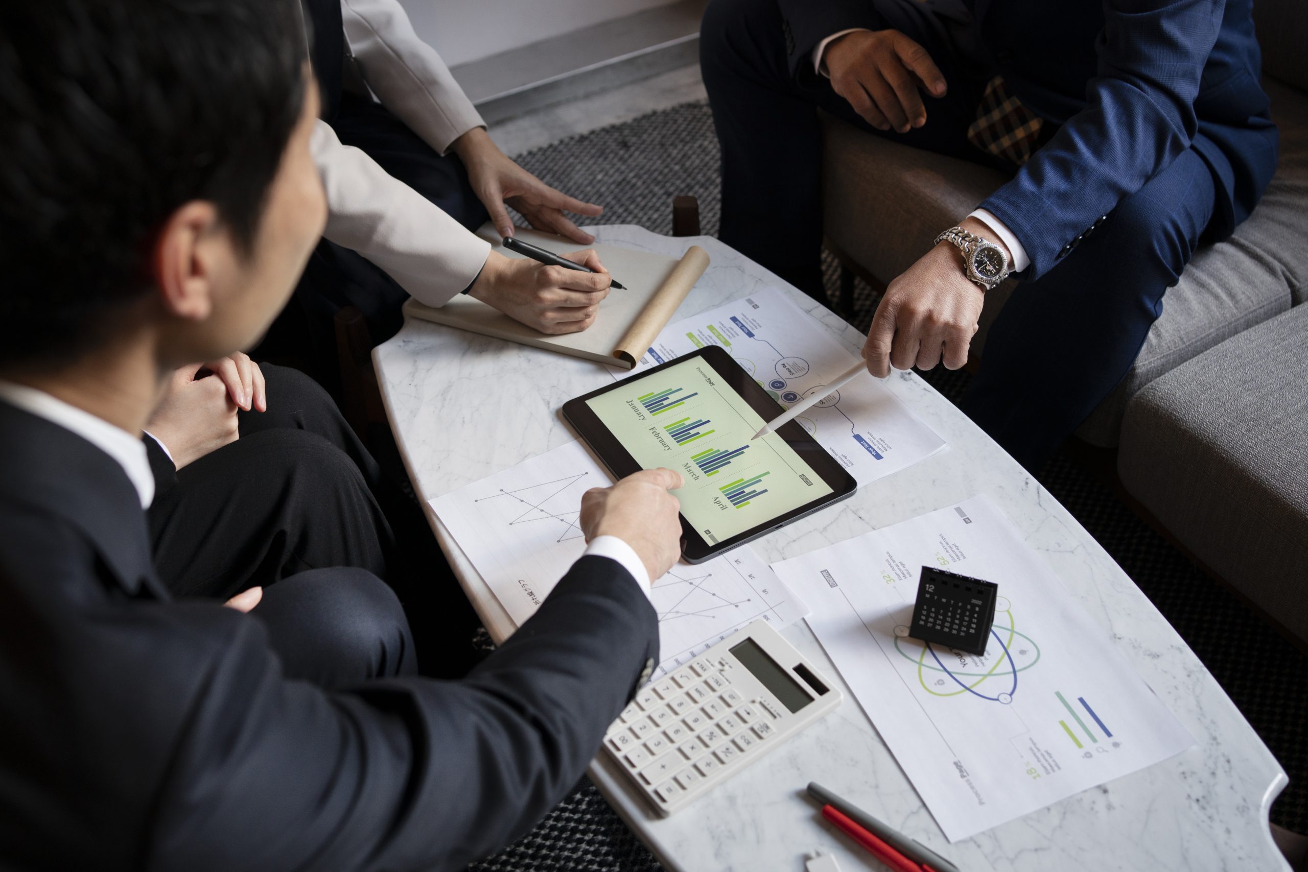 Management meeting with lots of graphs and paperwork